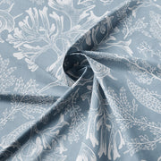 Close-up of Shellabrate Cornflower Blue fabric showing white seashell and coral motifs on a blue background