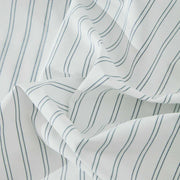 Close-up of Vale Shadow duvet cover fabric showing yarn-dyed blue pinstripe pattern on cotton percale