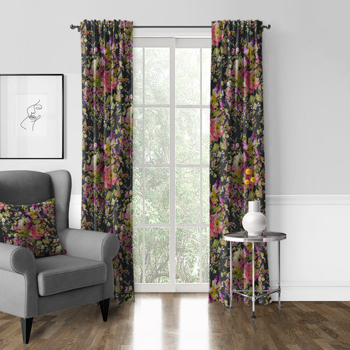 Blossom Charcoal pole top floral drapery panels framing a window beside a grey armchair and silver side table.