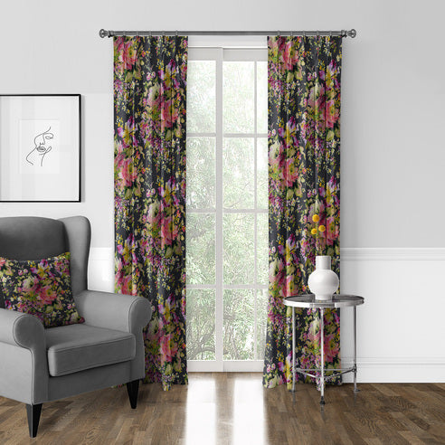 Blossom Charcoal floral drapery panels framing a tall window beside a grey armchair with a matching floral cushion.