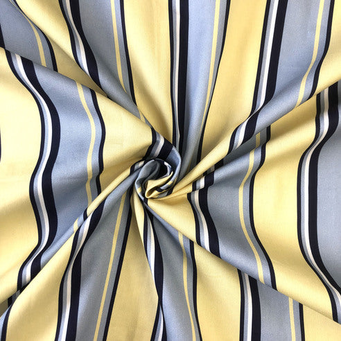 Gino Stripe bedding ensemble featuring vibrant multicolor striped pattern with butter yellow accents on premium cotton