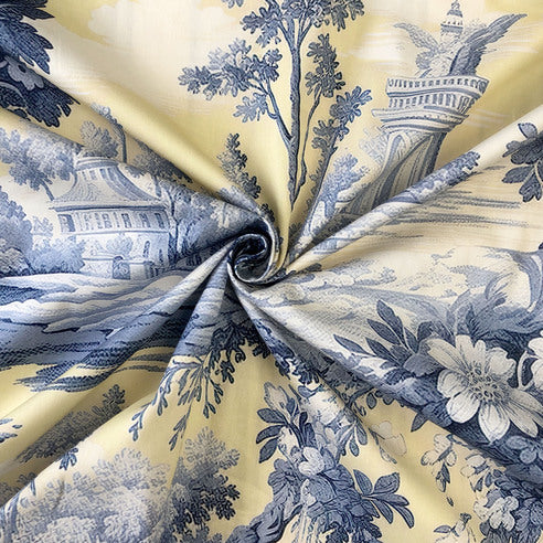 Close-up of Giverny floral motif showing impressionist-style blossoms on butter yellow cotton twill fabric