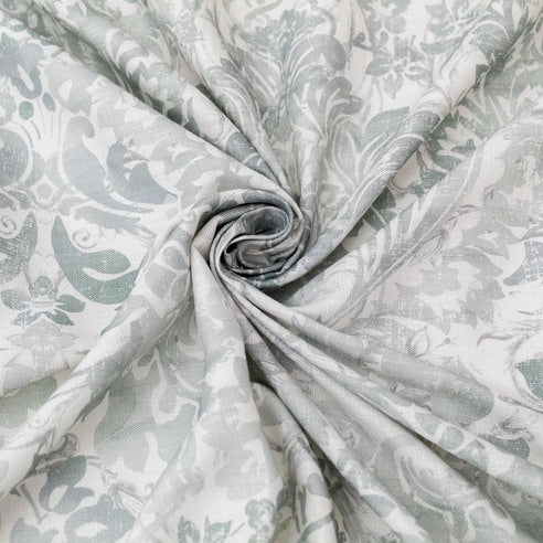 Roll of fabric with a floral pattern in sage and white