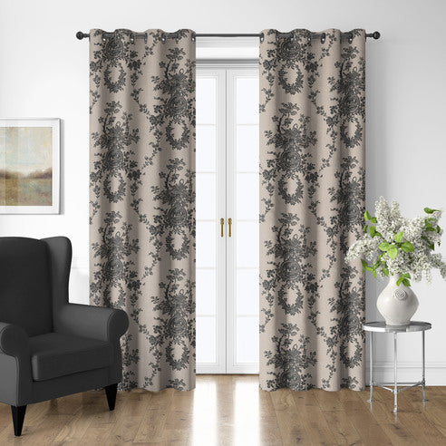 Country Lane Ebony grommet top drapery panels framing white French doors beside a charcoal armchair and silver side table.