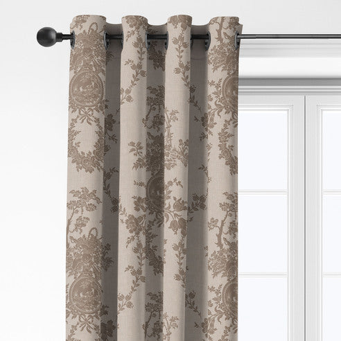 Close-up of Country Lane Natural grommet top drapery with taupe flowers and medallions on a beige background.