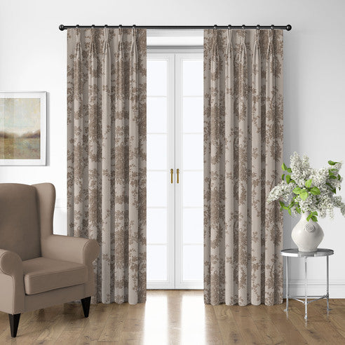 Country Lane Natural floral drapery panels framing white French doors beside a taupe armchair and silver side table.