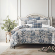 Dolce duvet cover set with painted forest design in soft blue, fog and fawn tones on bed, handcrafted in Canada