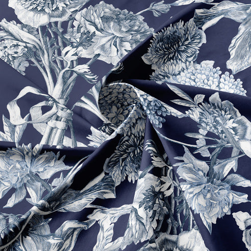 Floral fabric pattern with indigo and white flowers on a dark background