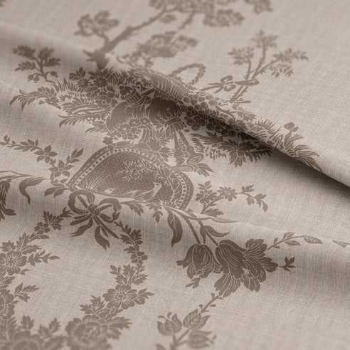 Textile with intricate floral and dragon design on a beige background