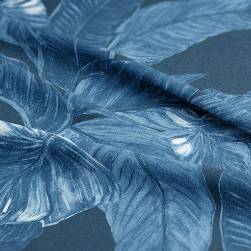 Close-up of Palomino Denim COVERLET set showing hand-drawn palm fronds against rich indigo denim cotton twill