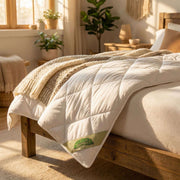 Natura Deluxe Washable Wool Duvet in white cotton sateen cover styled on a bed
