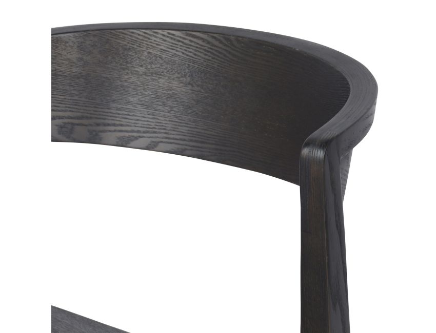 Close-up of Nicco dining chair with comfortable curved plywood back and arms in mocha walnut finish with ash veneer and visible wood grain
