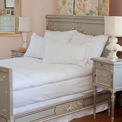 Genève Allergy Duvet Protector on elegant French-style bed with white bedding and ornate grey headboard