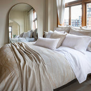 Saturna Jacquard Duvet Cover styled on a bed with pillows – 74% Cotton / 26% Linen, Fabric from Italy by St. Genève