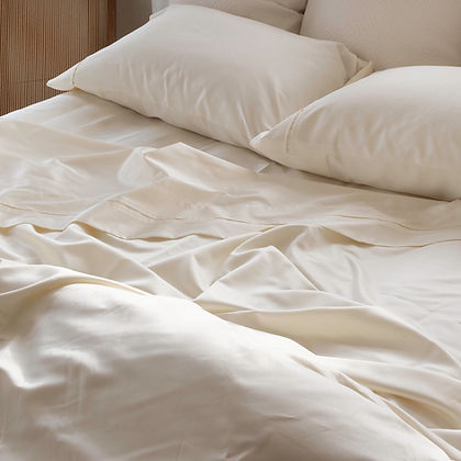 Regency Sateen Cream Duvet Cover draped on a bed – 100% Egyptian Extra-Long Staple Cotton, 380TC by St. Genève
