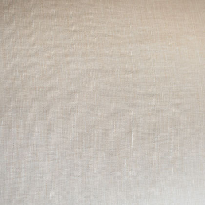 A close-up of a light beige textured fabric with a fine linen-like weave pattern.