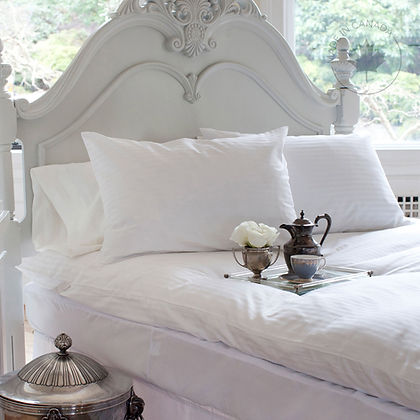 St. Genève Luxury Duvet Protector on white ornate bed with silver tea tray and white roses, bright airy bedroom