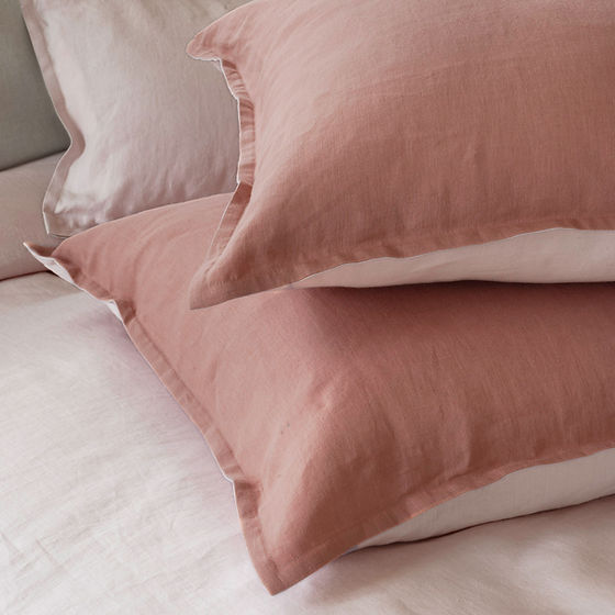 Echo Duo linen bedding styled on bed showing two-color reversible options - St Genève