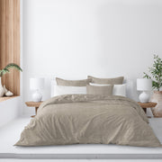 Elite Linen Natural duvet cover in beige with coordinating pillow shams on a bed