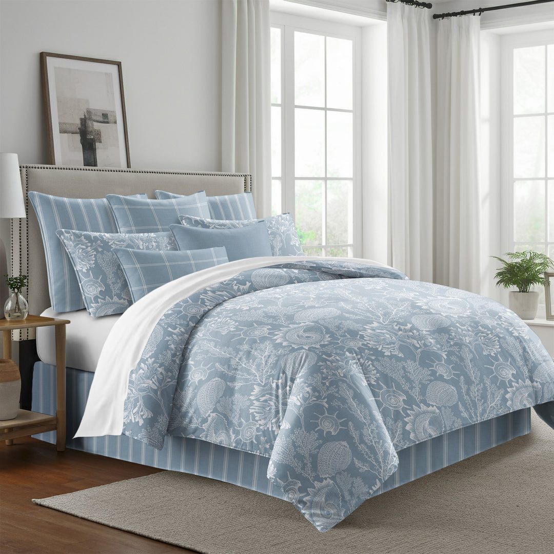 Shellabrate Cornflower Blue duvet cover with white seashell and coral patterns, styled with coordinating pillow shams