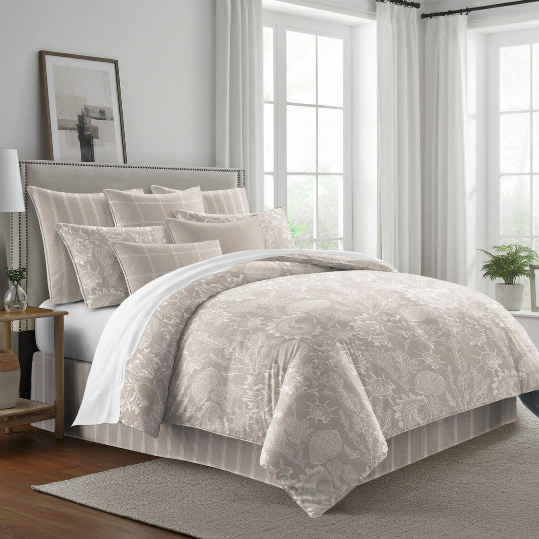 Shellabrate Natural duvet cover with ivory seashell and coral patterns on beige, styled with coordinating pillow shams