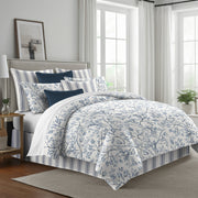 Tinsley duvet cover with blue leafy branches on white, styled with matching shams and navy accent pillows