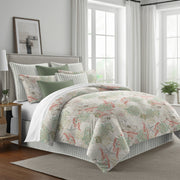 coral and green: Under the Sea duvet cover with coral pink and green marine motifs on a light background, styled with matching shams