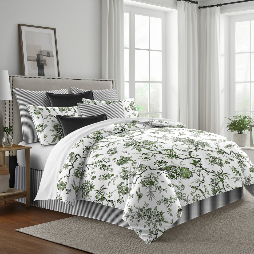 green: Tree Top duvet cover with green floral and branching patterns on white, styled with matching shams and black accent pillows