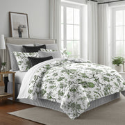 green: Tree Top duvet cover with green floral and branching patterns on white, styled with matching shams and black accent pillows