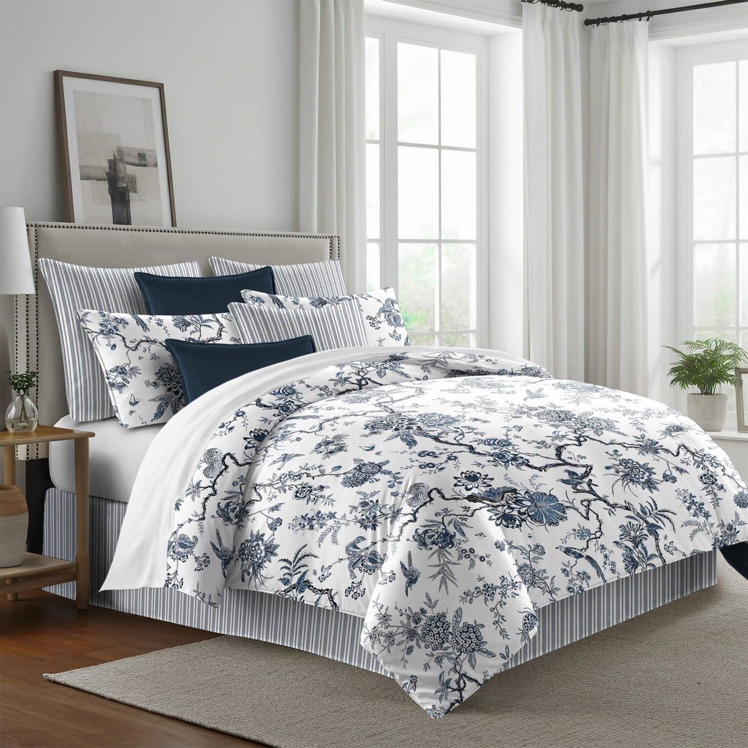 blue: Tree Top duvet cover with blue floral and branching patterns on white, styled with matching shams and navy accent pillows