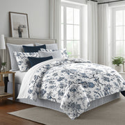 blue: Tree Top duvet cover with blue floral and branching patterns on white, styled with matching shams and navy accent pillows