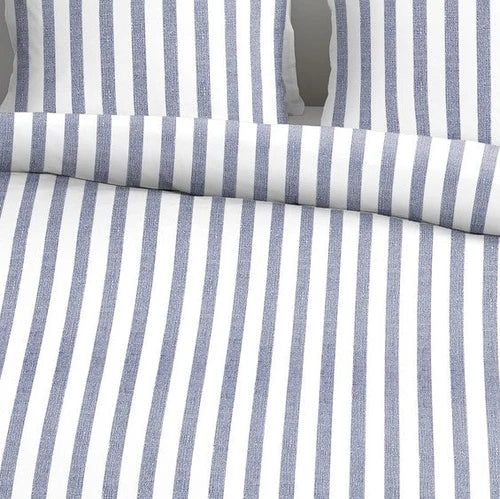 closer view: Close-up of Ally blue and white striped cotton duvet cover folded back beneath matching pillows