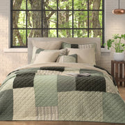 Broccolini green and cream patchwork pillow sham with striped, floral and solid panels on a white background.
