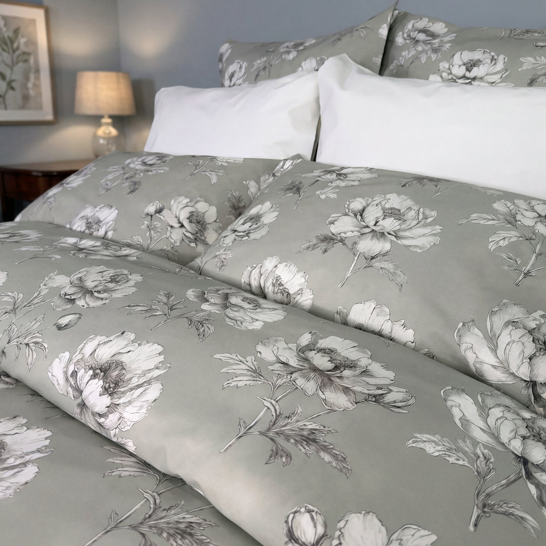 Close-up of Camelia floral print duvet cover in sage grey – soft percale cotton bedding by Cuddle Down
