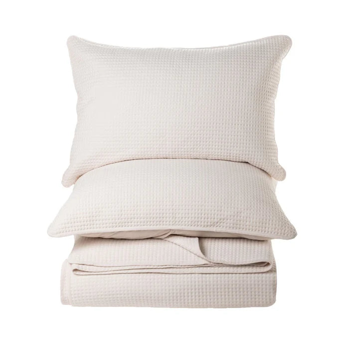 Atelier Solid Cream Quilt Set – soft polyester velvet with star imprints, styled on bed