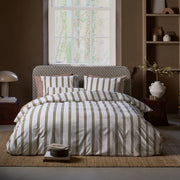 full bed: Dune ivory cotton duvet cover with tan and burgundy stripes, styled on a bed with matching pillows