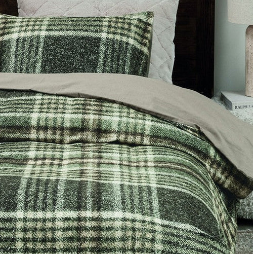 closer view: Close-up of Elliot green plaid flannel duvet cover with a plain beige reverse and matching pillow