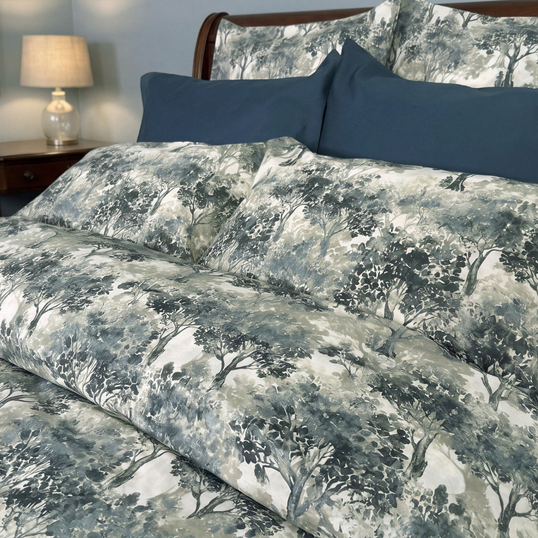 Close-up of Greenwood woodland tree print duvet cover in blue and grey – soft percale cotton bedding by Cuddle Down
