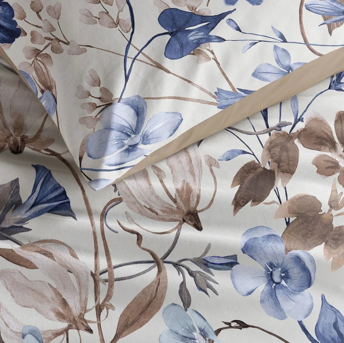 fabric detail: Loïse cotton fabric detail with blue and taupe flowers, trailing stems and a taupe-trimmed pillowcase