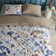 full bed: Loïse cotton duvet cover with blue and taupe flowers on a cream background, styled with a plain taupe reverse