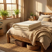 Natura Ultimate Latex Topper displayed on a rustic wood bed in a natural boho bedroom setting