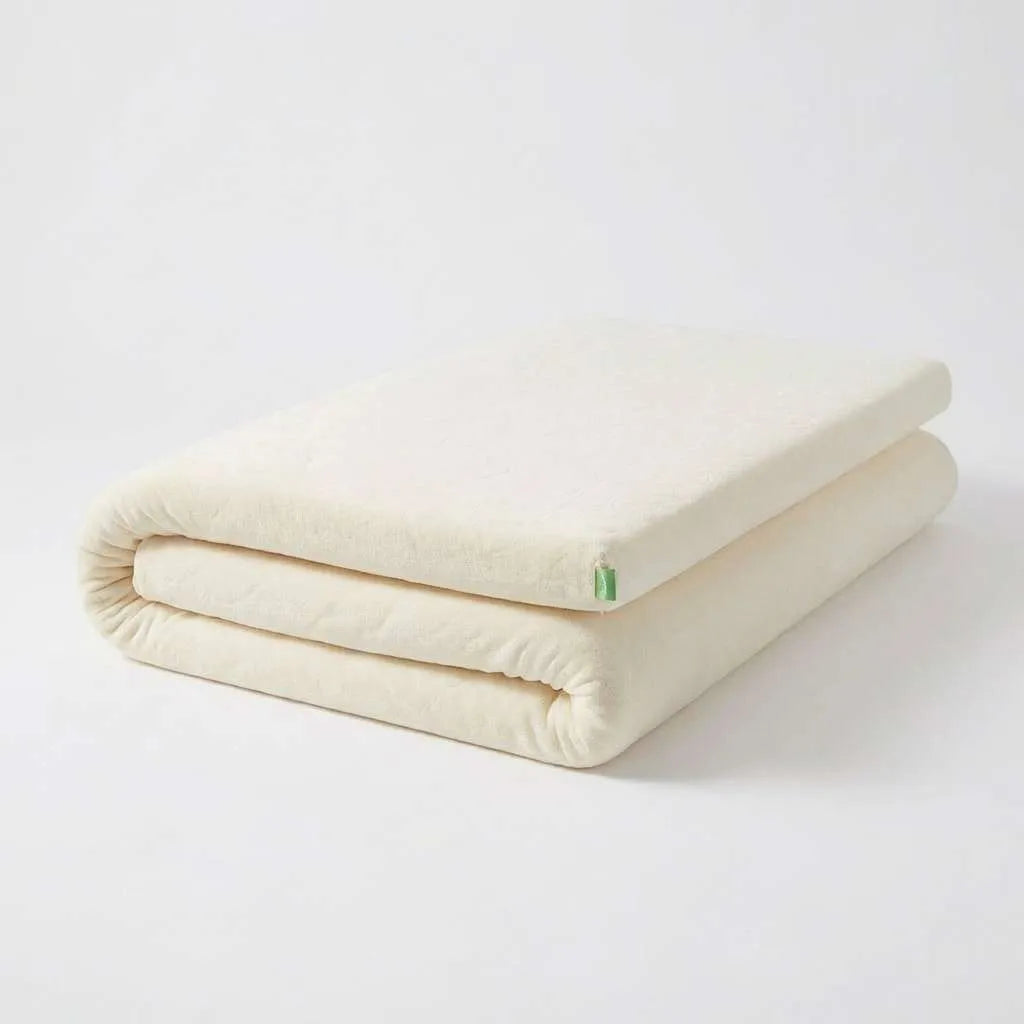 Natura Ultimate Latex Topper folded, showing organic knitted cotton cover with Natura green label