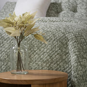 Maggie green quilt close-up – delicate white floral pattern on cotton