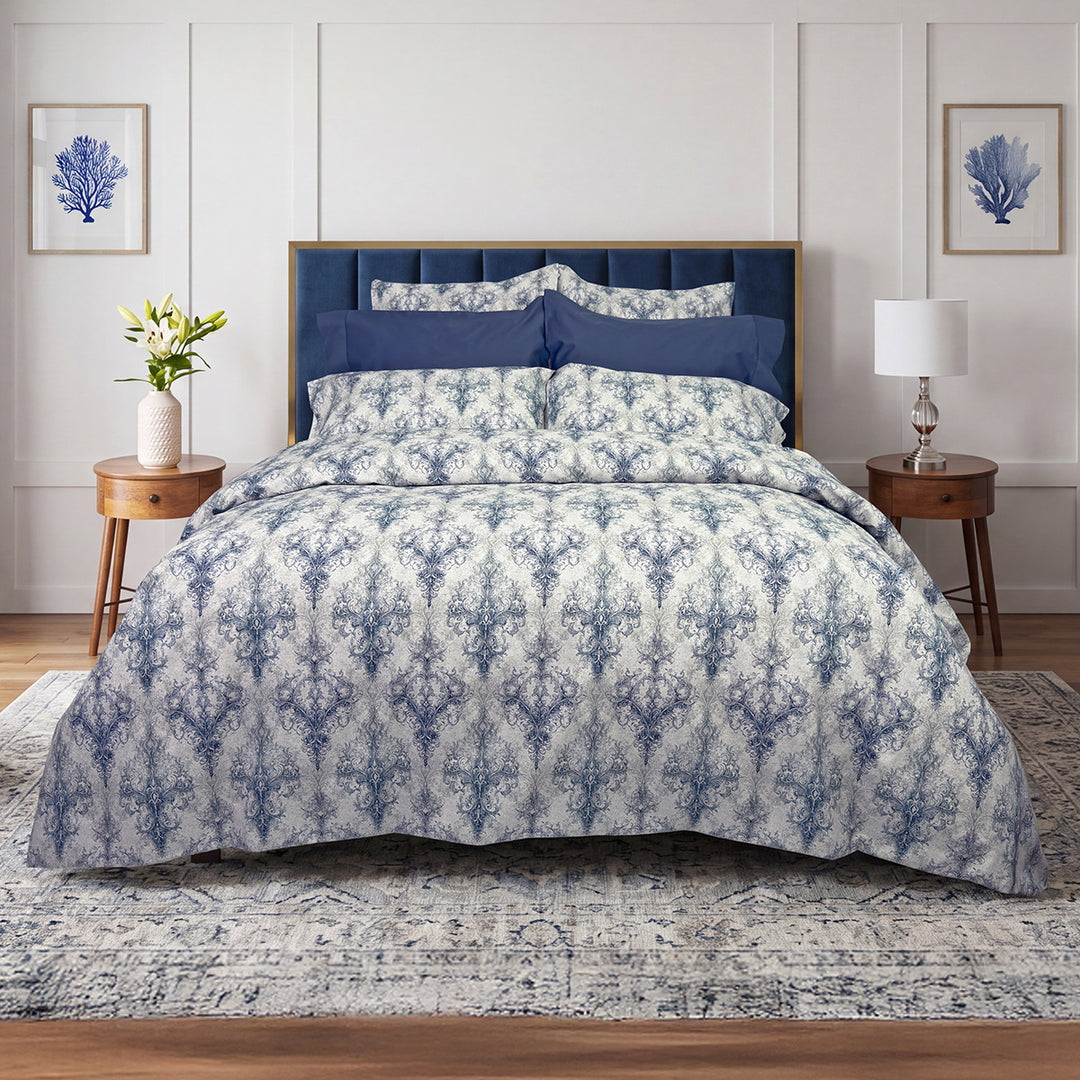 Manor damask duvet cover and shams styled on a bed with navy blue upholstered headboard – 100% long-staple cotton by Cuddle Down
