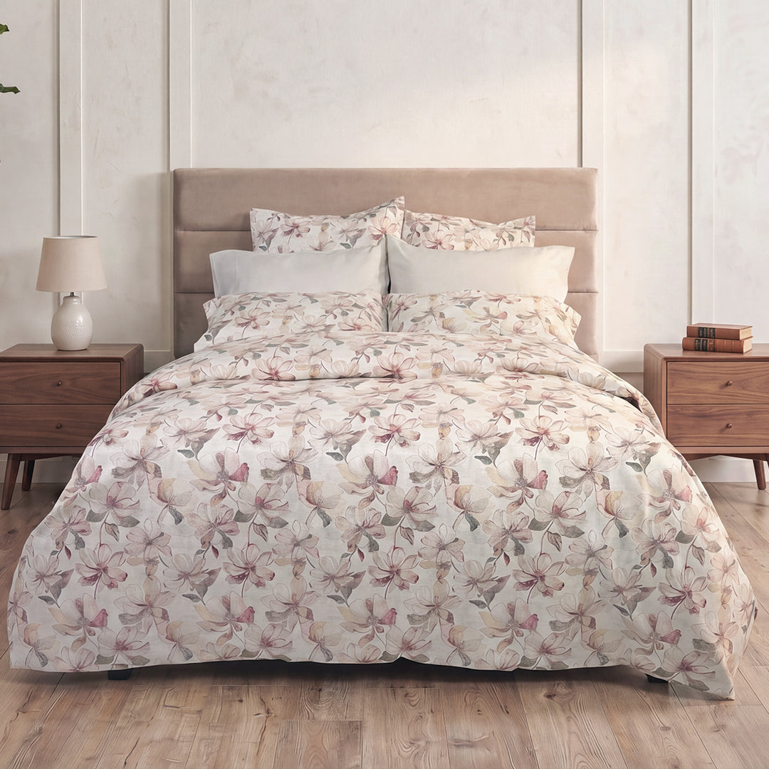 Petals watercolour floral duvet cover and shams styled on a bed with beige linen headboard – 100% long-staple cotton by Cuddle Down
