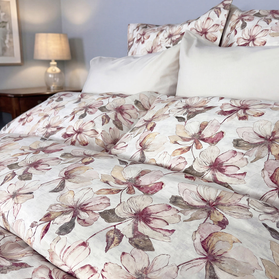 Close-up of Petals large magnolia floral print duvet cover in blush pink and mauve on white – soft percale cotton bedding by Cuddle Down
