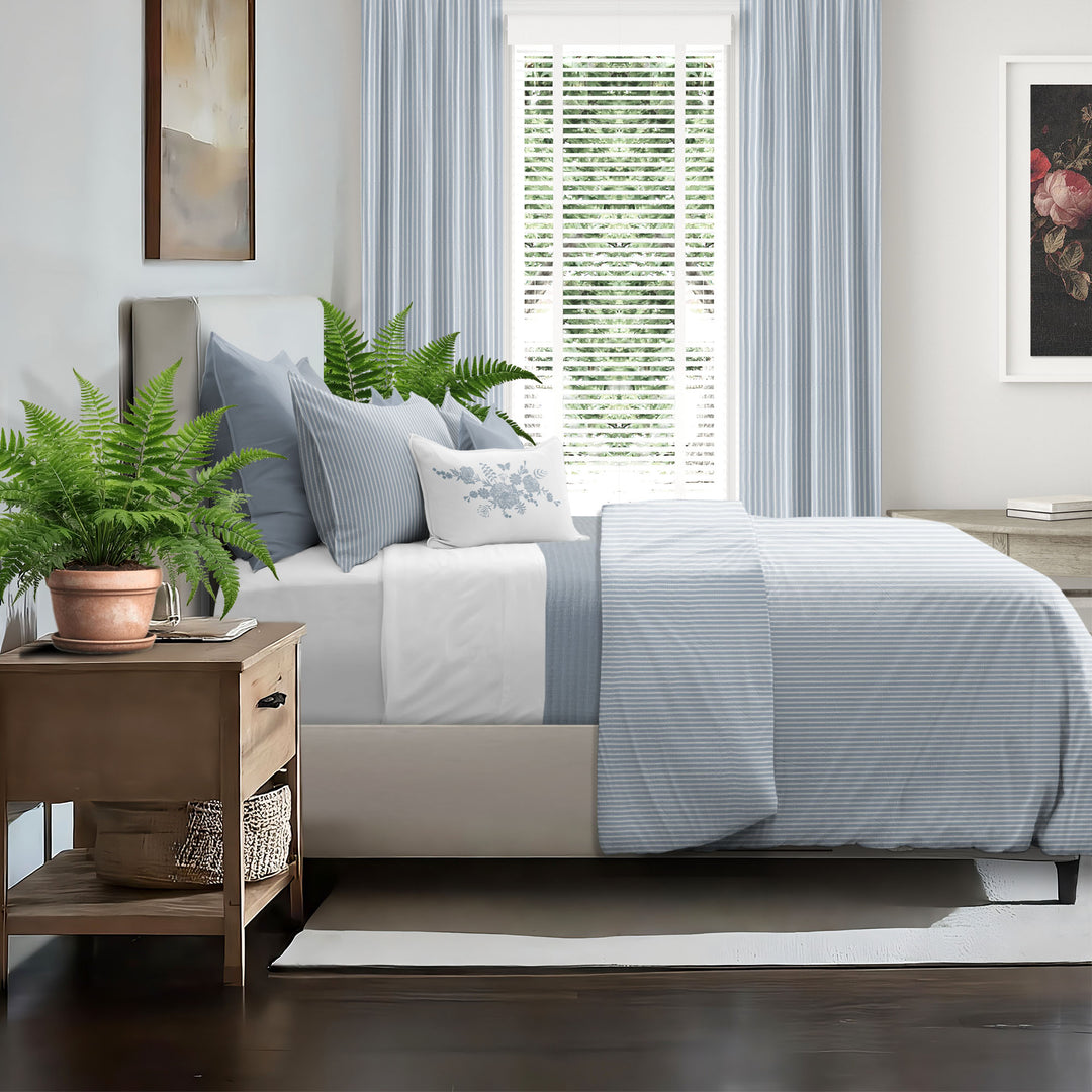 Ruben Stripe Cornflower pillow shams styled on bed – OEKO-TEX certified bedding