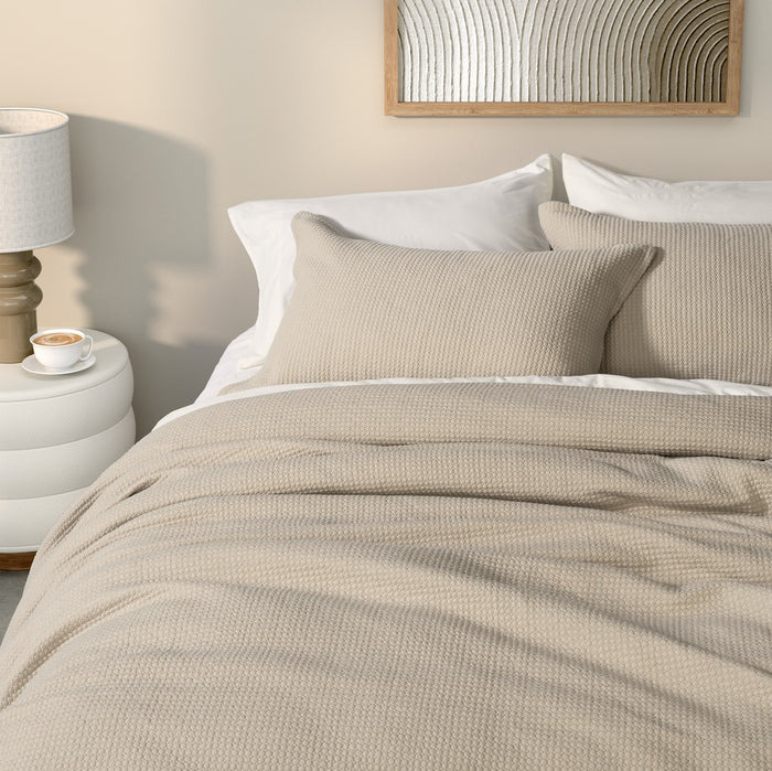 full bed: Rustic natural beige jersey quilted duvet cover with textured stitching, styled on a bed with matching pillows