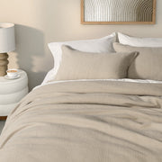 full bed: Rustic natural beige jersey quilted duvet cover with textured stitching, styled on a bed with matching pillows