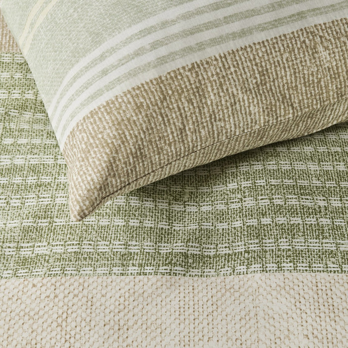 fabric detail: Shitake cotton duvet cover and matching pillowcase showing woven-look patterns and fine stripes in green and beige